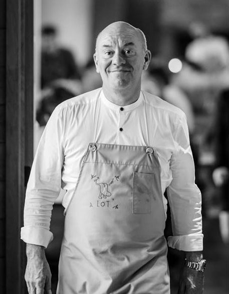 Smiling male chef walking.