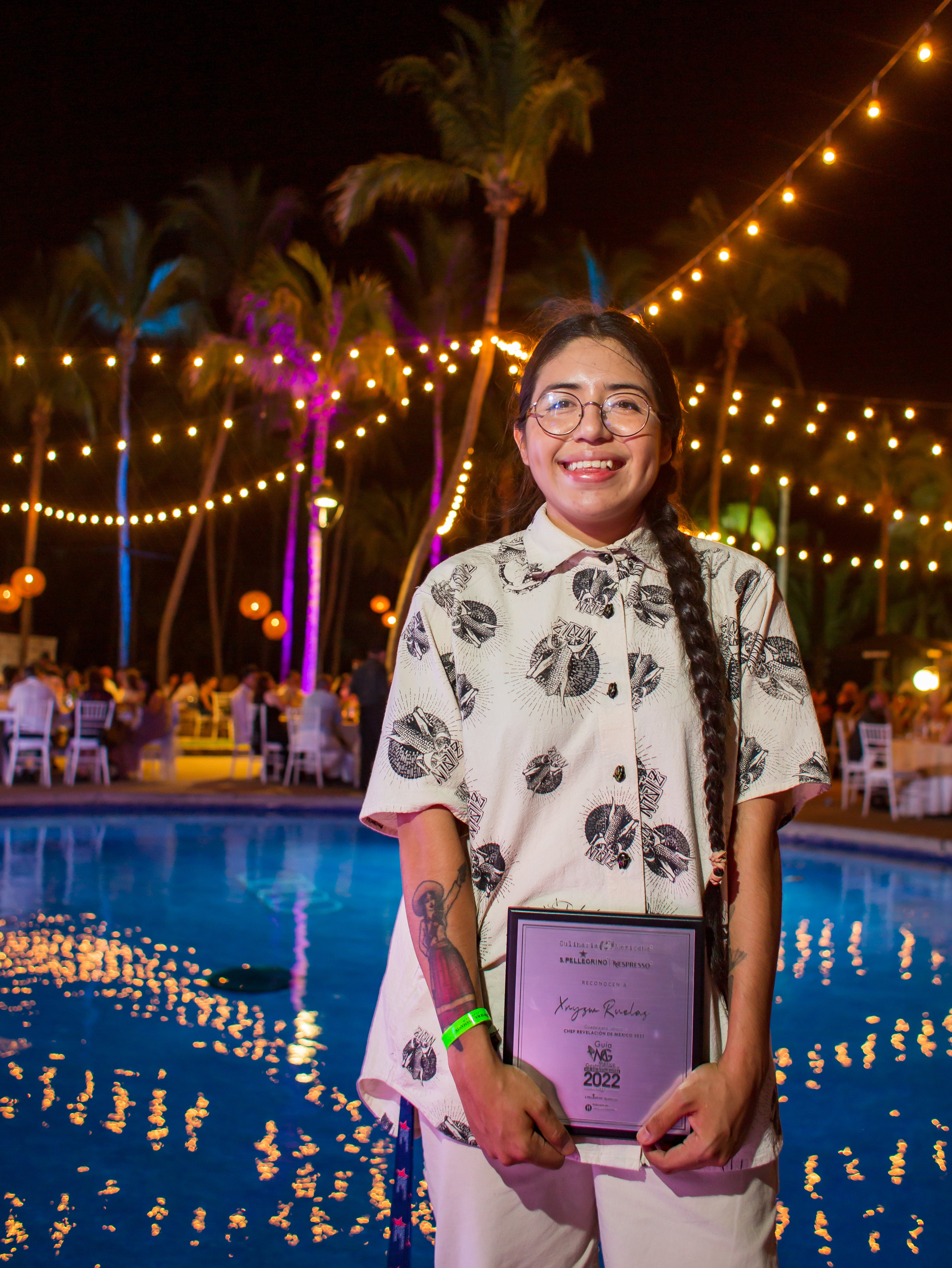 Female chef holding an award.