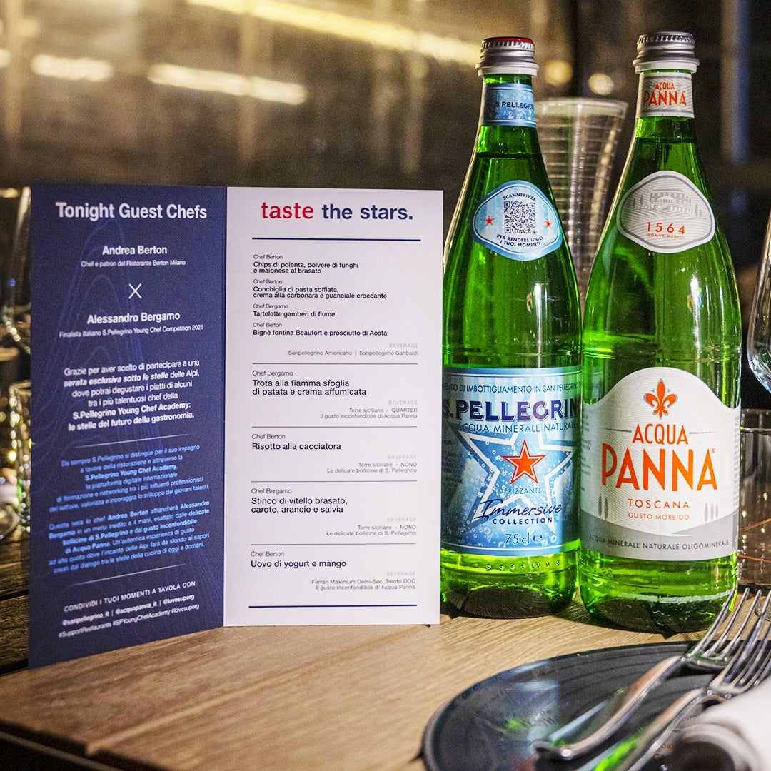 San Pellegrino's water bottles next to a menu.